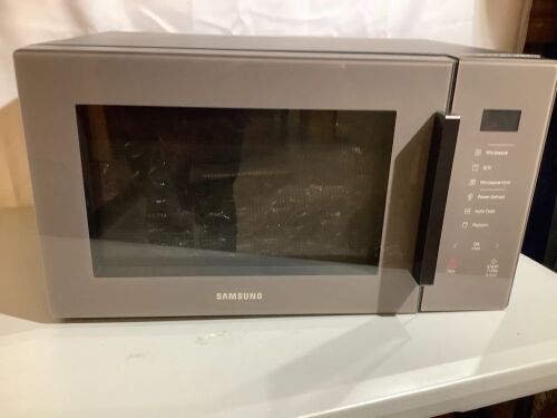Samsung 1.1 cu. ft. Countertop Microwave with Grilling Element in Charcoal Gray, Dent on Bottom, Appears New - Lot 87