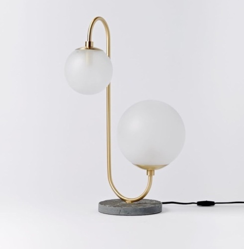 A west elm exclusive, we worked with New York City-based design studio Pelle to create this table lamp. You'lllove the soft light its two salt-blasted glass globes giveoff., Like New, Retail - $249 - Lot 263
