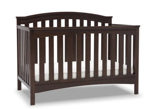 The Waverly 6-in-1 Convertible Crib by Delta Children features elegant crown molding and beadwork on both the headboard and footboard. - Delta Children.$199.99 - Lot 92