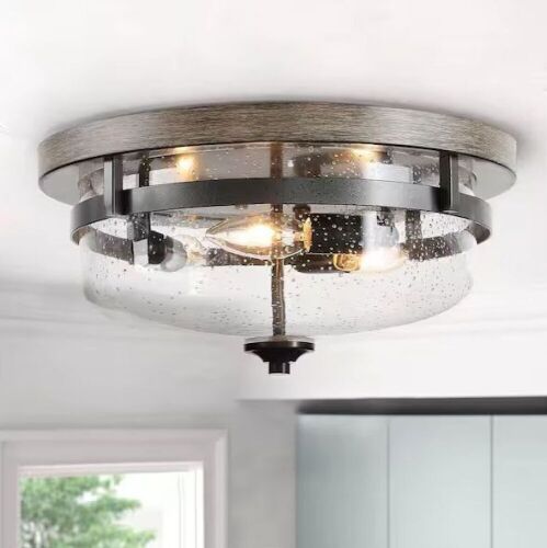 LNC 13.5 in. 3-Light Bronze Flush Mount Ceiling Light with Drum Clear Seeded Glass Shade and Round Faux Aged Wood Plate - Lot 61