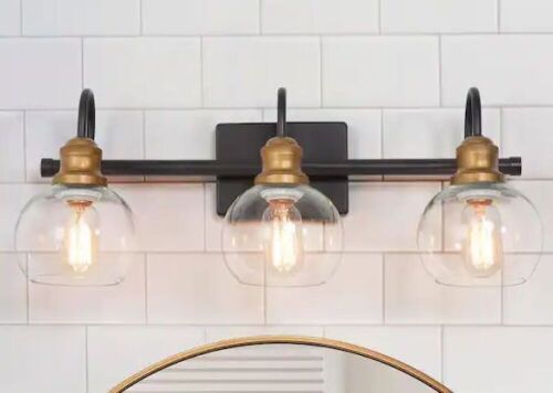 LNC 22 in. 3-Light Modern Aged Brass and Black Bathroom Vanity Light with Clear Glass Globe Shades - Lot 446