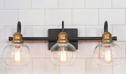 LNC 22 in. 3-Light Modern Aged Brass and Black Bathroom Vanity Light with Clear Glass Globe Shades - Lot 186